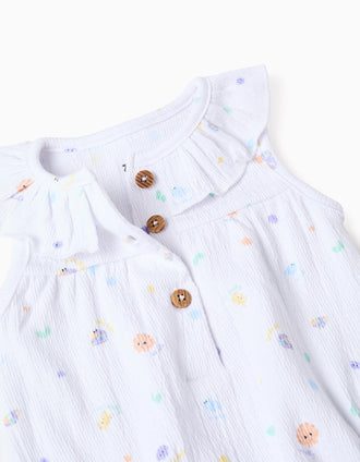 Sleeveless cotton romper with motif and ruffles for newborn girls, white