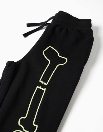 Pantalón deportivo con estampado que brilla en la oscuridad para niño, negro
